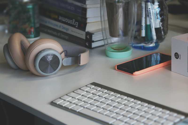 Keyboard headphones and mobile phone on desk